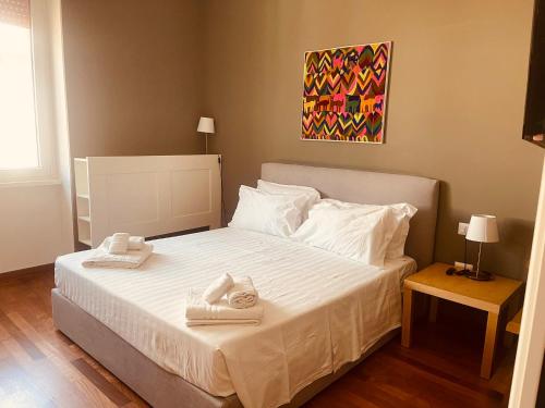 a bedroom with a bed with two towels on it at Margherita's House in Bari
