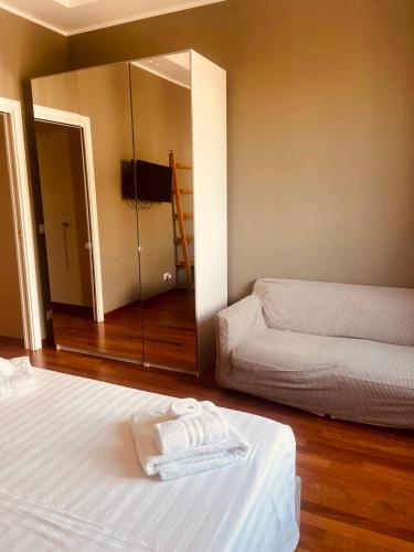 a hotel room with two beds and a mirror at Margherita's House in Bari