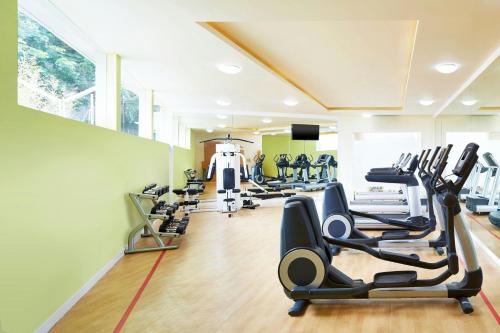 a gym with treadmills and elliptical machines at Sheraton Bandung Hotel & Towers in Bandung