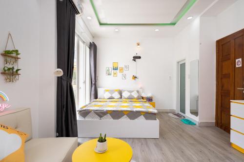 a small room with a bed and a table at Happy house studio in Ho Chi Minh City