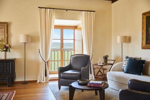 a living room with a couch and a chair and a window at Abadia Retuerta LeDomaine in Sardoncillo