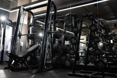 a gym filled with lots of dumbbells at Luxury City Retreat Perfect for Business & Families & Free Gym By The Pocklington - The New Walk Suite in Leicester