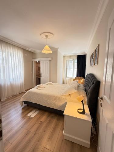 a bedroom with a bed and a couch at Seaview 2BR 2BA Apartment in Antalya Lara Cliffs in Antalya