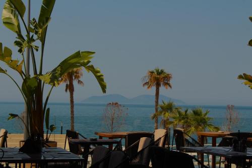a view of the ocean from a restaurant with tables and chairs at Azar Luxury Suites in Vlorë