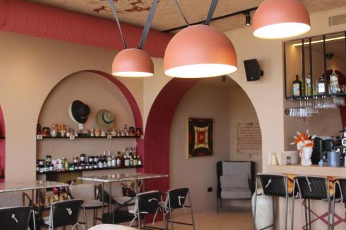 a restaurant with tables and chairs and lights at Azar Luxury Suites in Vlorë