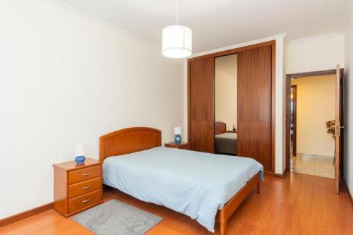 a bedroom with a bed and a dresser and a mirror at Douro 3 Bedrooms Magic Mountain Landscape in Vila Flor