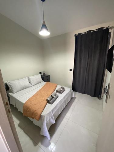 a bedroom with a bed and a black curtain at Nebulous Apartment 2 in Zakynthos Town