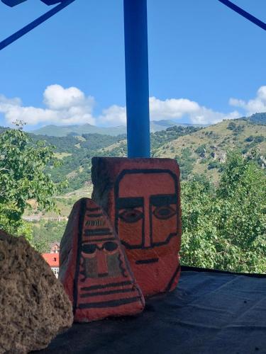 a vase sitting on a table with a view at Ojakh in Dilijan