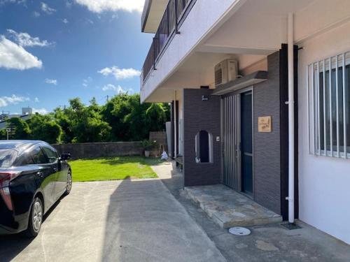 a car parked in front of a house at villa live okinawa in Uruma