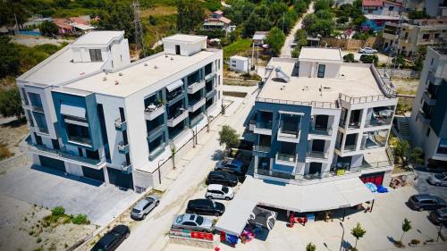 an aerial view of a building with cars parked in a parking lot at Aren Penthouse in Vlorë