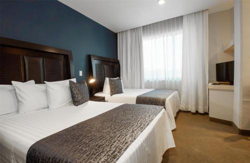 Postel nebo postele na pokoji v ubytování Best Western Real Tula Express