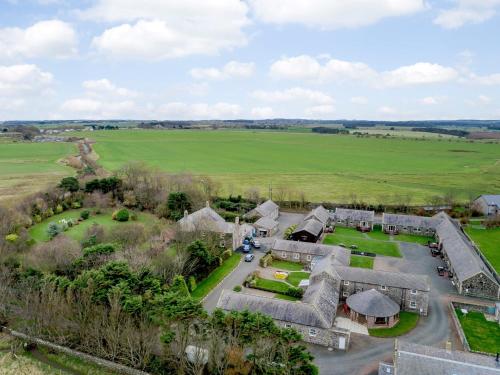 an aerial view of a house with a field and trees at 2 Bed in Newton-by-the-Sea 80485 in Newton by the Sea