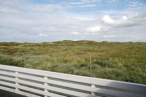 a view of a field with a white fence at Lovely Summer House On Natural Grounds in Frøstrup