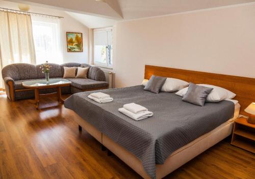 a bedroom with a bed with two towels on it at Villa MB in Augustów