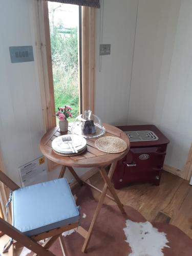 a small table in a room with a stove at Doris in Wedmore