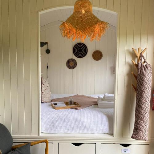 a room with a bed in a cabinet with a mirror at Doris in Wedmore