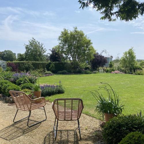 two chairs and a table in a garden at Doris in Wedmore