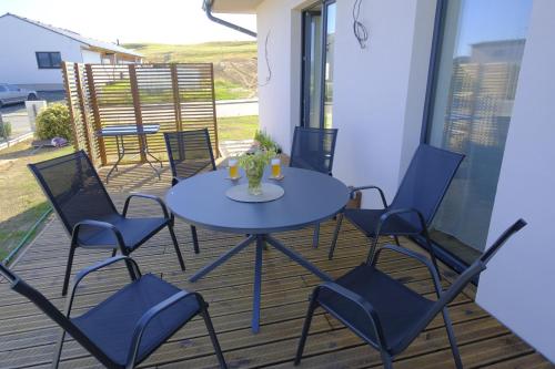a blue table and chairs on a deck at Červene maky - red poppies in Malý Slavkov