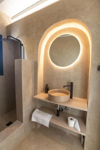 a bathroom with a sink and a mirror at Amazē Mykonos in Mikonos