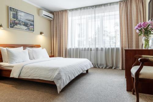 a hotel room with a bed and a window at PecherSky Hotel in Kyiv