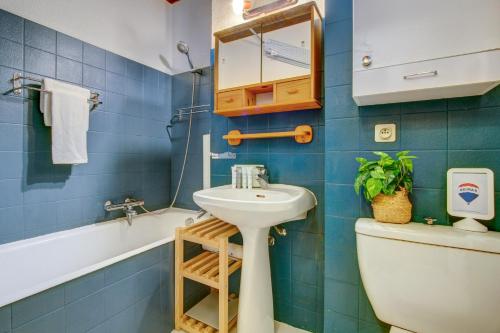 a bathroom with a sink and a toilet and a mirror at Edelweiss in Morzine