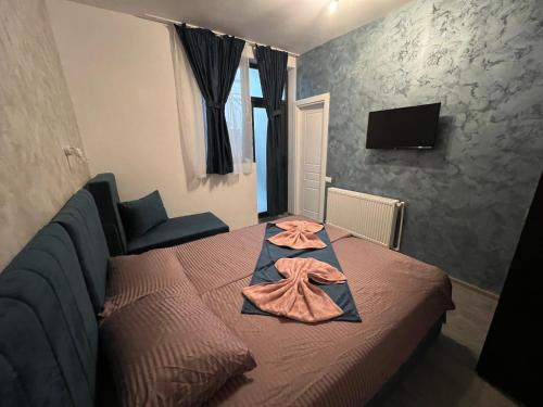 a bedroom with a bed with a robe on it at Ama29 in Constanţa