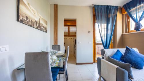a dining room and living room with a table and chairs at Casetta di Giò by Rentbeat in Rome