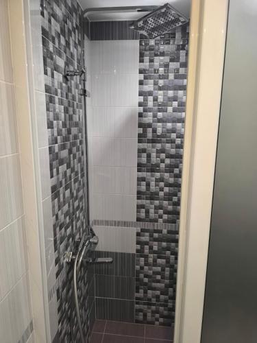 a bathroom with a shower with a glass door at студио КОМФОРТ в центъра на град Сандански in Sandanski