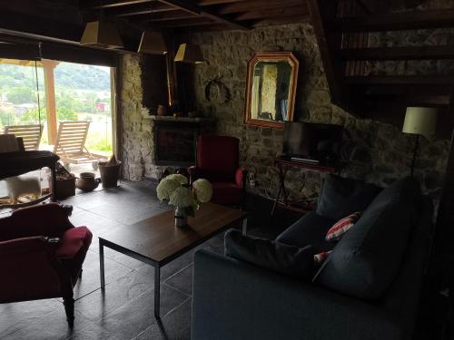 a living room with two couches and a table at Casa Maruxela in Borines