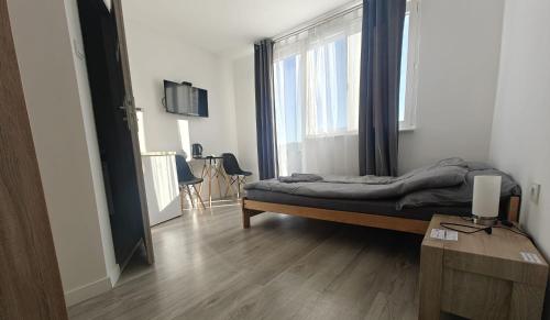 a bedroom with a bed and a large window at Sara Resort II in Wisełka