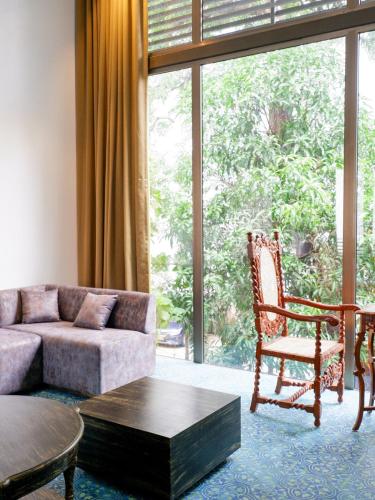 a living room with a couch and a chair at Dia Hotels and Homes Nerul Goa - Villas and Apartments in Nerul