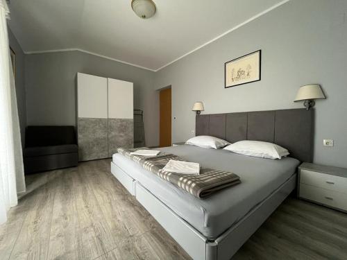 a bedroom with a large bed in a room at Apartments and Rooms Lanča in Rab