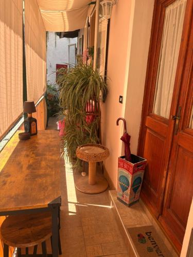 a hallway of a house with a table and a bench at B&b Carducci in Gorizia