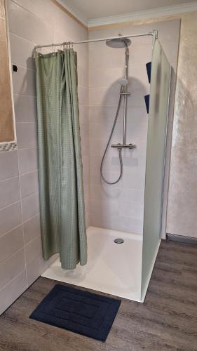 a shower with a shower curtain in a bathroom at Bett und Bike Dithmarschen in Epenwöhrden