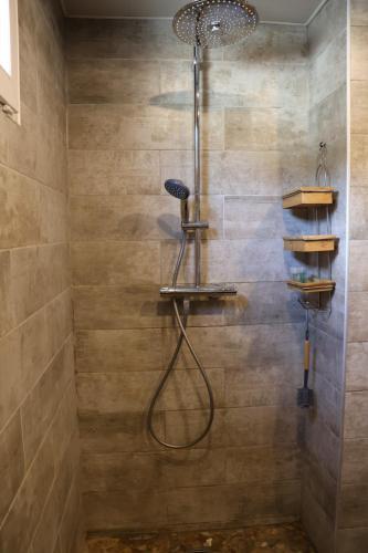 a shower with a shower head in a bathroom at Le loft in Villeneuve-Saint-Georges