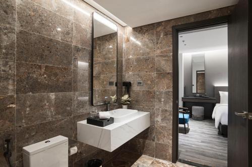 a bathroom with a sink and a mirror at GrandView Hotel & Residence Hanoi in Hanoi