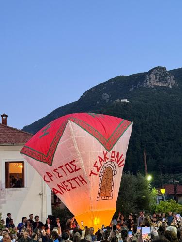 a crowd of people holding a kite in front of a mountain at Tsakoniki filoxenia! in Leonidion