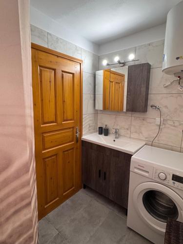 a kitchen with a washing machine and a sink at Tsakoniki filoxenia! in Leonidion