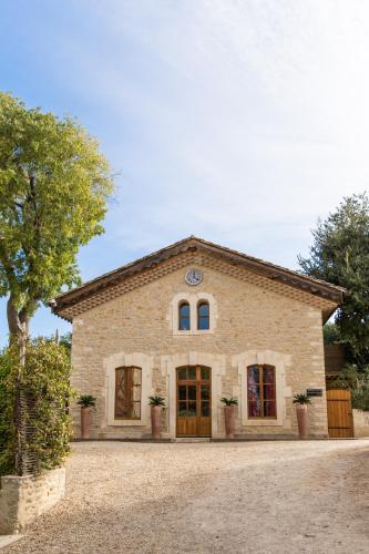 a large stone building with a tree in front of it at Domaine de Verchant & Spa - Relais & Châteaux in Montpellier