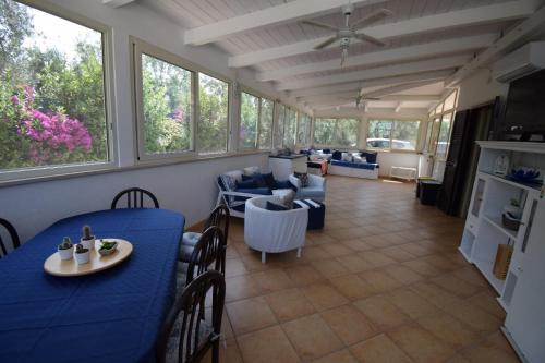 a kitchen and living room with a blue table and chairs at Villa MEMA in Bisceglie