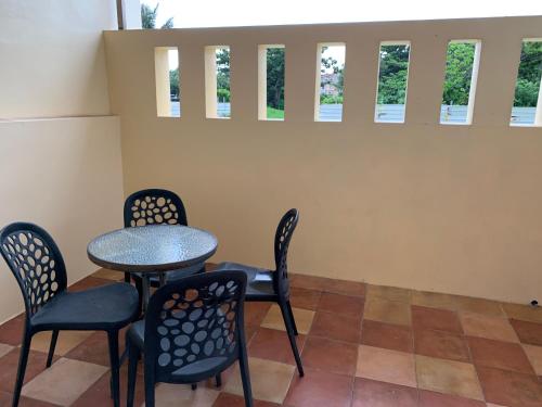 a table and chairs in a room with windows at Island on the Sea in Kenting