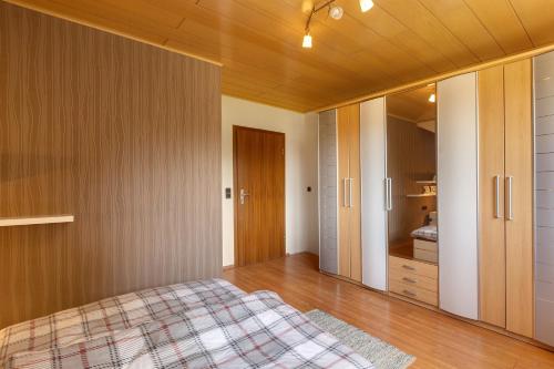 a bedroom with a bed and a wooden ceiling at Wohung zum Ausblick in Plettenberg