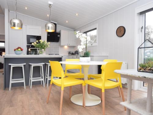 a kitchen with a yellow dining table and chairs at 2 Bed in St Andrews 72435 in Anstruther
