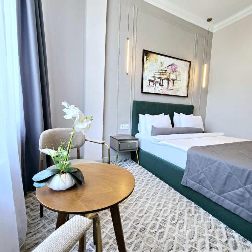 a hotel room with a bed and a table at Maestro Address Baku Hotel in Baku