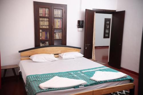 Кровать или кровати в номере Pudumana Homestays
