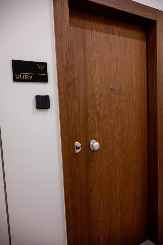 a wooden door in a room with a sign on it at Volaka Luxury Suites in Kos Town