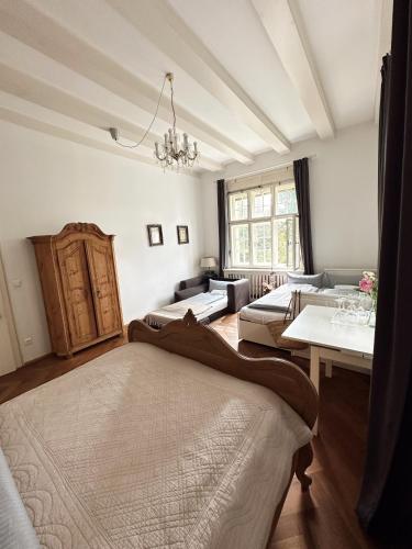 a living room with two beds and a table at Schloss Mörlbach in Icking