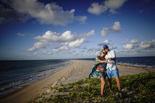a man and a woman standing on the beach at Castelo Beach Resort in Inhambane