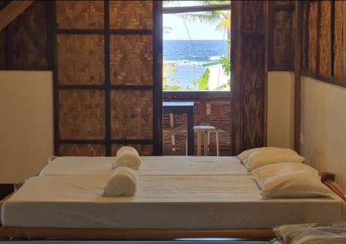 Postel nebo postele na pokoji v ubytování Coleto Siargao