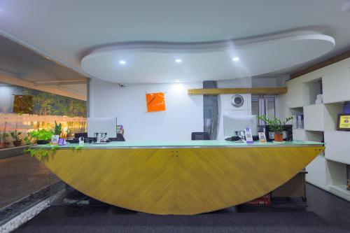 an office with a large yellow counter in a room at Hotel Athome & Serviced Apartments by Deccan Serai Hotels in Hyderabad